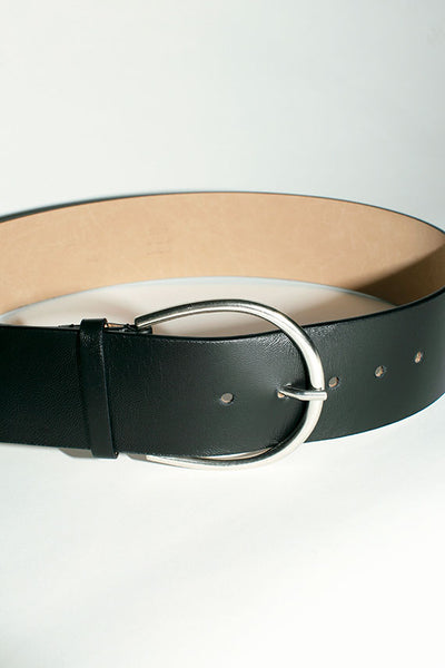 Closeup of oval shaped silver frame style buckle on Maryam Nassir Zadeh Vetiver belt in black leather.